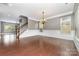 Spacious dining room with hardwood floors, wainscoting, and staircase to upper level at 3004 Fallondale Rd, Waxhaw, NC 28173