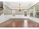 Spacious dining room with hardwood floors, wainscoting, and large windows providing ample natural light at 3004 Fallondale Rd, Waxhaw, NC 28173