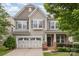 Charming two-story home featuring a two-car garage, stone accents, and manicured landscaping at 3004 Fallondale Rd, Waxhaw, NC 28173