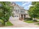 Charming two-story home featuring a two-car garage, stone accents, and lush green landscaping at 3004 Fallondale Rd, Waxhaw, NC 28173