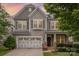 Charming two-story home featuring a two-car garage, stone accents, and manicured landscaping at 3004 Fallondale Rd, Waxhaw, NC 28173