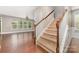 View of staircase and front hallway with hardwood floors and a view of the dining room at 3004 Fallondale Rd, Waxhaw, NC 28173