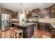 Modern kitchen features a large granite island, stainless steel appliances, and bar stool seating at 3004 Fallondale Rd, Waxhaw, NC 28173