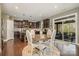 Open kitchen with dark wood cabinetry, island, modern appliances, and adjacent breakfast nook at 3004 Fallondale Rd, Waxhaw, NC 28173