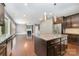 Open kitchen and living area with hardwood floors and a kitchen island with granite countertops at 3004 Fallondale Rd, Waxhaw, NC 28173