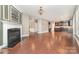 Open-concept living area with a fireplace flowing into the kitchen space with hardwood floors at 3004 Fallondale Rd, Waxhaw, NC 28173