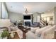 Comfortable living room featuring a fireplace, TV, hardwood floors, and plenty of natural light at 3004 Fallondale Rd, Waxhaw, NC 28173