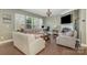 Bright living room features hardwood floors, large windows, a cozy fireplace, and stylish furnishings at 3004 Fallondale Rd, Waxhaw, NC 28173