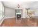 Open living room with hardwood floors and a fireplace at 3004 Fallondale Rd, Waxhaw, NC 28173