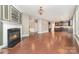 Open-concept living area with a fireplace flowing into the kitchen space with hardwood floors at 3004 Fallondale Rd, Waxhaw, NC 28173