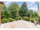 Beautiful tiled patio surrounded by a lush, well-maintained yard with mature trees and shrubbery at 3004 Fallondale Rd, Waxhaw, NC 28173