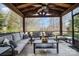 Relaxing covered patio with comfortable seating, ceiling fan, and views of the surrounding nature at 3004 Fallondale Rd, Waxhaw, NC 28173
