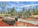 Community playground with slides, climbing structures, and benches surrounded by natural landscaping at 3004 Fallondale Rd, Waxhaw, NC 28173