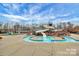 Community pool with a winding water slide, poolside seating, and beautiful landscaping at 3004 Fallondale Rd, Waxhaw, NC 28173