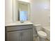 Bathroom showcasing a gray vanity with modern fixtures and a tiled floor at 3904 Craig Ave, Charlotte, NC 28211