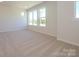 Spacious bedroom features neutral carpet and natural light from multiple windows at 3904 Craig Ave, Charlotte, NC 28211