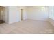 Open bedroom features neutral carpet and natural light from a large window at 3904 Craig Ave, Charlotte, NC 28211