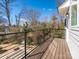 Outdoor deck with railing and scenic views of the surrounding trees at 3904 Craig Ave, Charlotte, NC 28211