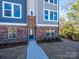 Modern townhome with brick and siding facade, showcasing a walkway to the front door at 3904 Craig Ave, Charlotte, NC 28211