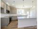 Modern kitchen featuring an island with granite countertops, gray cabinetry, and stainless appliances at 3904 Craig Ave, Charlotte, NC 28211