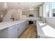 Bright kitchen with stainless steel appliances, granite counters, and stylish light fixtures at 3904 Craig Ave, Charlotte, NC 28211