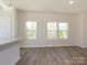 Sun-filled living room featuring hardwood floors and large windows with scenic views at 3904 Craig Ave, Charlotte, NC 28211