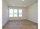 Sun-filled living room featuring hardwood floors and multiple windows at 3904 Craig Ave, Charlotte, NC 28211