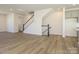 Open-concept living area featuring hardwood floors and a staircase at 3904 Craig Ave, Charlotte, NC 28211