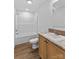Bathroom featuring a single vanity, toilet, tub, and wood-look floor at 451 Lookout Dam Rd, Statesville, NC 28625