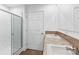 Bathroom featuring a glass-enclosed shower, double sinks, and modern fixtures at 451 Lookout Dam Rd, Statesville, NC 28625