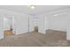 Spacious bedroom with carpeted floor, natural light, and multiple access doors at 451 Lookout Dam Rd, Statesville, NC 28625