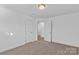 Bedroom with neutral carpet, white walls, and two doors at 451 Lookout Dam Rd, Statesville, NC 28625