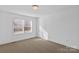 Well-lit bedroom with neutral carpeting and a window at 451 Lookout Dam Rd, Statesville, NC 28625