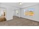 Cozy bedroom with natural light, carpeted floor, and a connecting door at 451 Lookout Dam Rd, Statesville, NC 28625