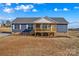 Charming single-story home featuring a covered porch, vinyl siding, and a well-lit exterior at 451 Lookout Dam Rd, Statesville, NC 28625
