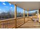 View from the covered front porch showcasing wooden railings and natural light at 451 Lookout Dam Rd, Statesville, NC 28625