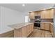 Well-lit kitchen featuring wooden cabinets, stainless steel appliances, and a center island with a granite countertop at 451 Lookout Dam Rd, Statesville, NC 28625