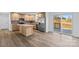 Modern eat-in kitchen with stainless steel appliances, wood cabinets, granite countertops, and sliding glass doors to the back at 451 Lookout Dam Rd, Statesville, NC 28625