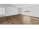 Living room featuring wood-look flooring, neutral walls, and an inviting entrance at 451 Lookout Dam Rd, Statesville, NC 28625