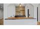A modern bar area with a live edge countertop, wood paneling, and ample counter space at 4786 Heather Ln, Denver, NC 28037