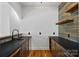 Bar area with dark cabinets, granite countertop, wood-paneled walls, and open shelving at 4786 Heather Ln, Denver, NC 28037