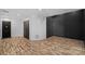 Basement area featuring stylish vinyl wood floors, black accent wall, and ample storage space at 4786 Heather Ln, Denver, NC 28037