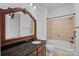 Bathroom with a wooden vanity, granite countertop, and a tile shower-tub at 4786 Heather Ln, Denver, NC 28037