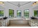 Bright bathroom features a soaking tub with lake views, granite counters, and stylish black vessel sinks at 4786 Heather Ln, Denver, NC 28037