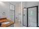 Modern bathroom with granite vanity, glass shower doors, tile flooring, and an accessible walk-in closet at 4786 Heather Ln, Denver, NC 28037