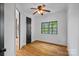 Bedroom features wood floors, white walls and trim, and a lake view window at 4786 Heather Ln, Denver, NC 28037