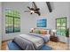 Bedroom with a plush bed, wooden nightstands, vibrant art, and a calming blue rug at 4786 Heather Ln, Denver, NC 28037