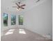 Bedroom with neutral carpet, multiple windows providing natural light and scenic views at 4786 Heather Ln, Denver, NC 28037