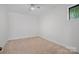 Minimalist bedroom with neutral carpet, white walls, ceiling fan, and a window at 4786 Heather Ln, Denver, NC 28037