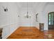 Formal dining room with wainscoting, chandelier, and hardwood floors at 4786 Heather Ln, Denver, NC 28037